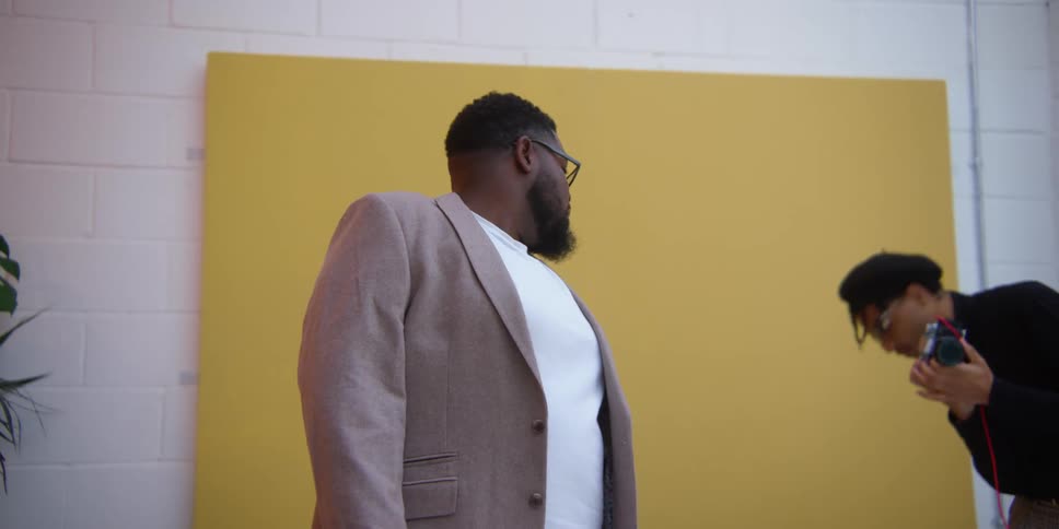 Men doing a photo shoot with a laptop and a face