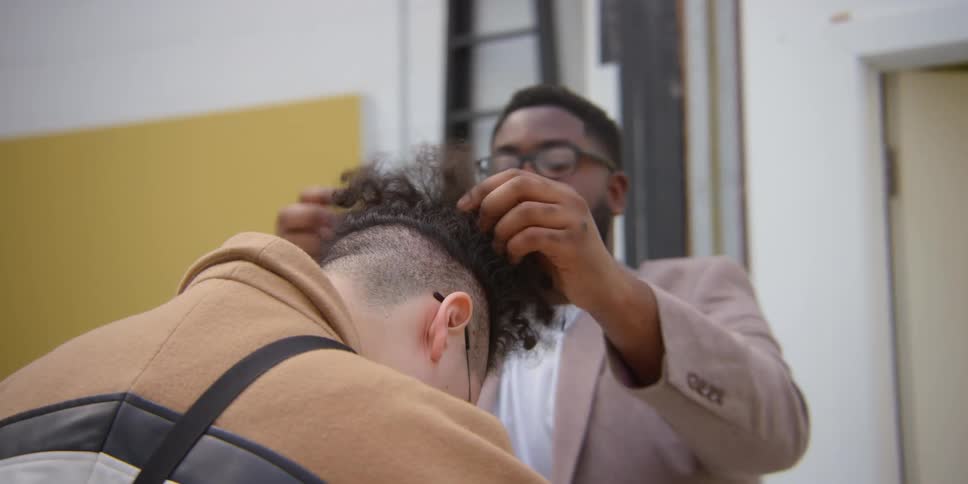 A stylist prepares a group of models for a photoshoot