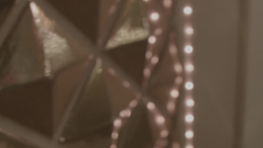 Shiny gold reflective surface going in and out of focus
