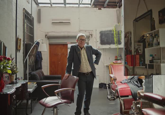 Man in suit inside his barbershop
