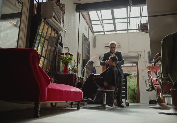 Barber using a clipper on his clients hair