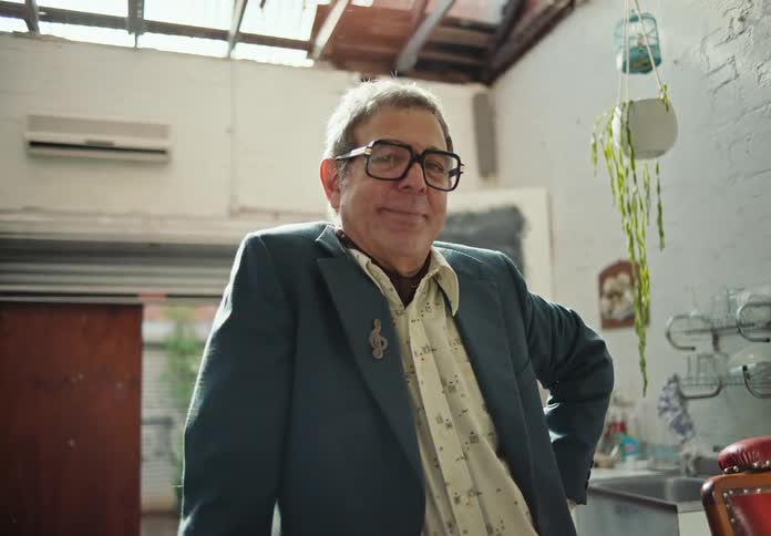 Portrait of a man wearing prescription glasses giving a slight smile