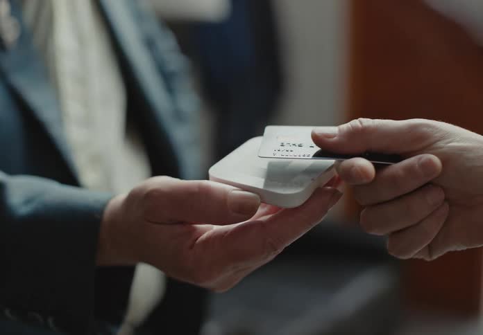 A man taps his credit card to pay