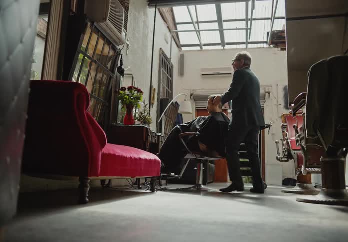 A barber styles a mans hair