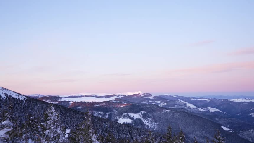 Snow covered mountains stretch away into the distance