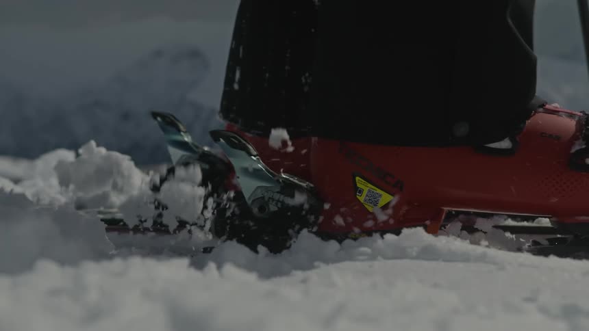 Close up of a skiers foot straps in to ski
