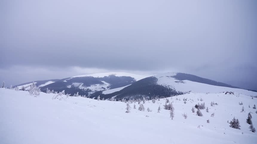 Panorama of snowcovered mountains on a cloudy day