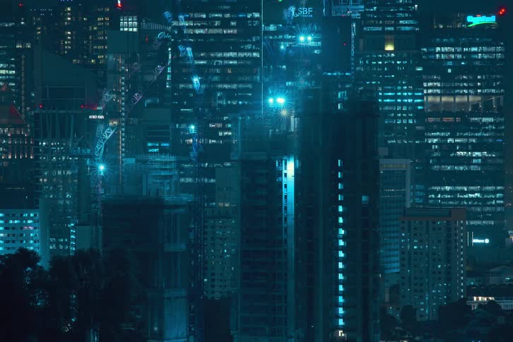 Time lapse of buildings being constructed at night filling the screen