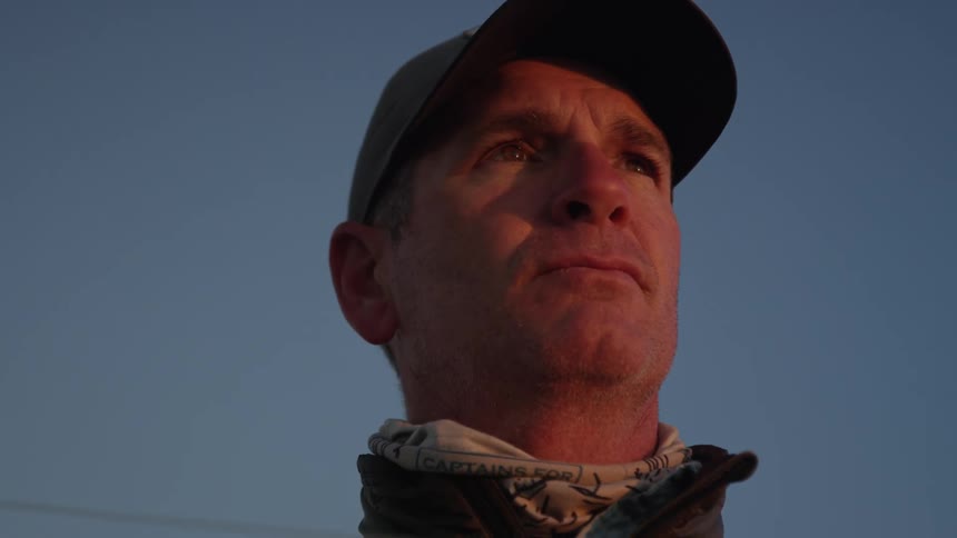 Portrait of a concentrated man holding a fishing rod