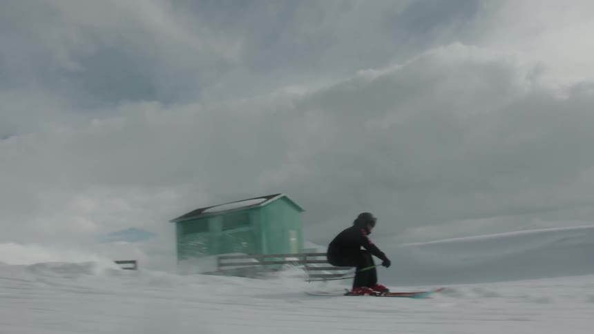 A skier jumps on the snowy slope