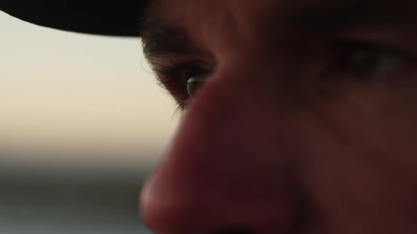 The face of a person who is looking sideways and winking his eye