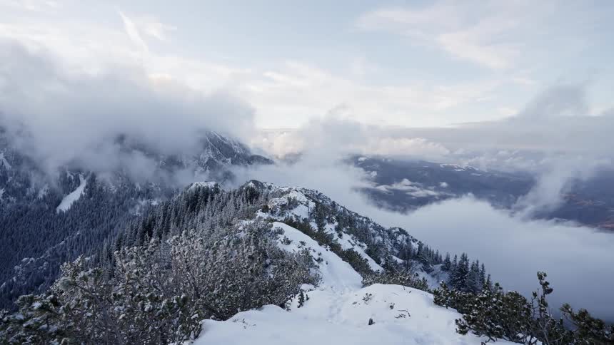 Aerial landscape of arctic mountain range covered in snow and mist