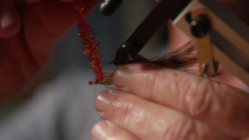 Extreme close up of a mans hands setting up a fishing lure