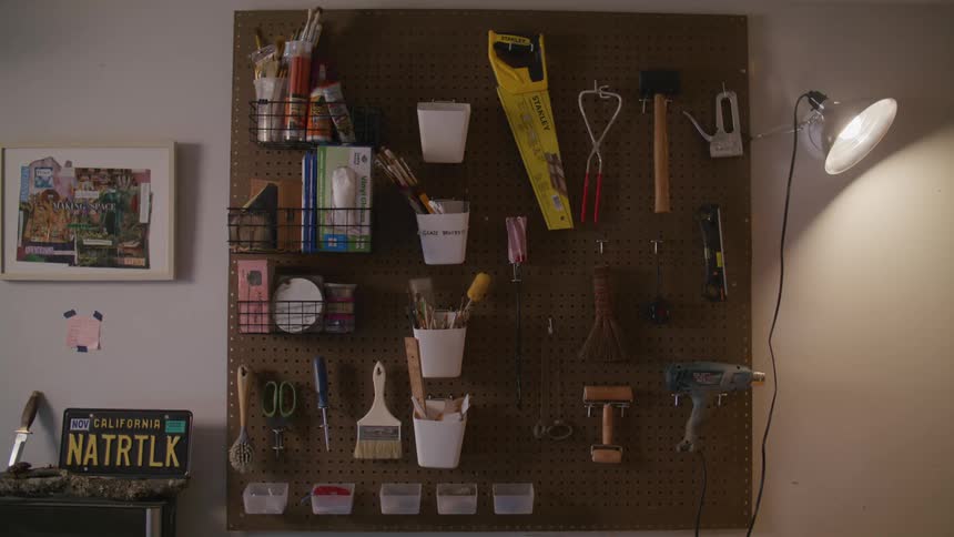 A wall with tools hanging in a store