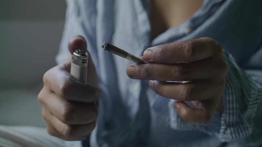 Close up of a woman lighting a cigarette