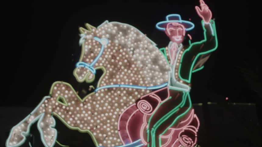A flashing sign of a man on a horse