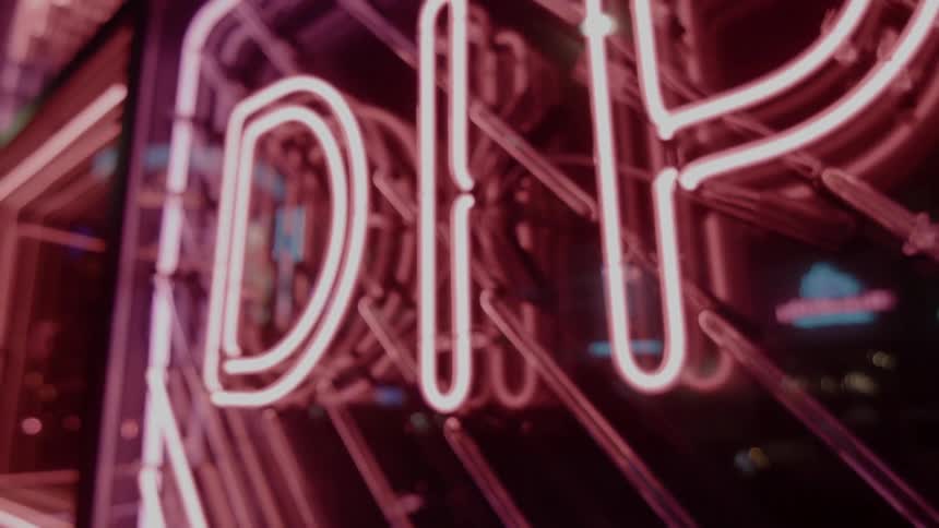 Red and pink neon signs blinking on a window