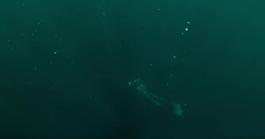 Submerged in the depths of the ocean with sunlight