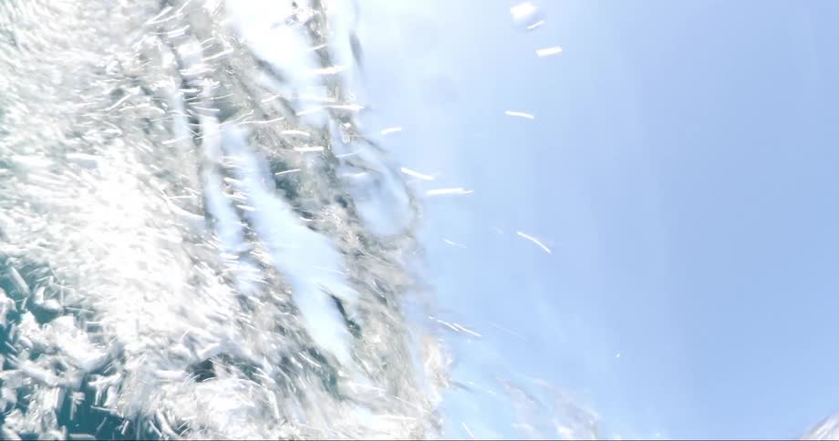 A giant ocean wave rolls through the water