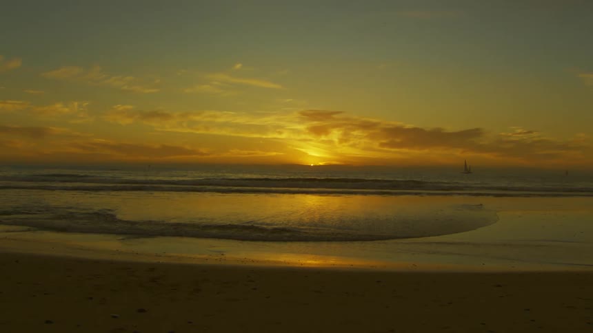 The sun is setting on the beach