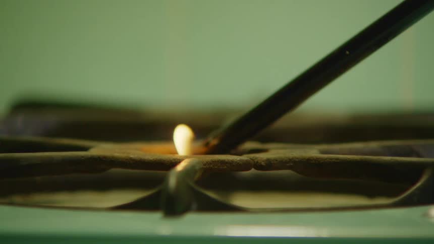 Long tubed igniter lights gas burner