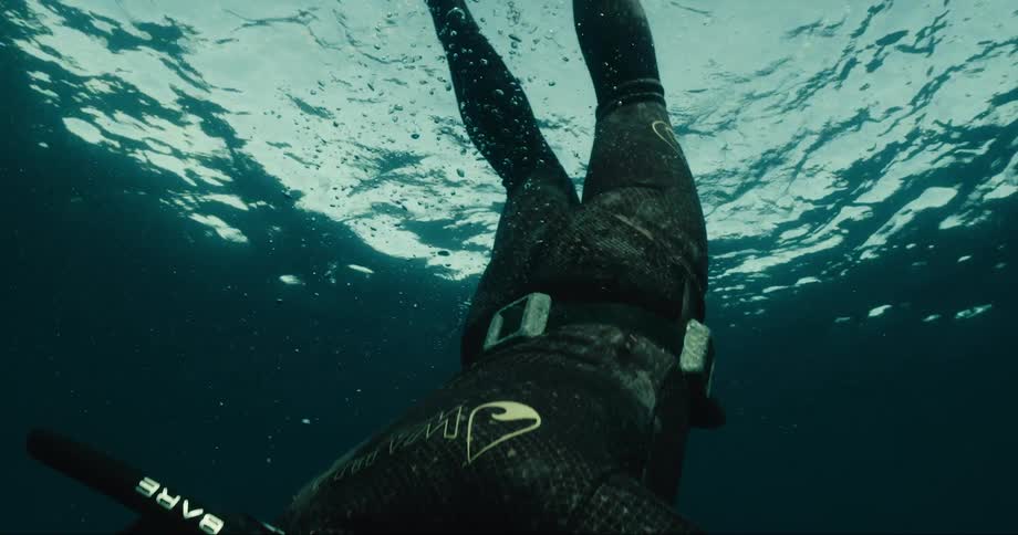 A person diving to the bottom of the ocean