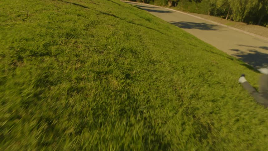 Man and a woman rolling down the lawn