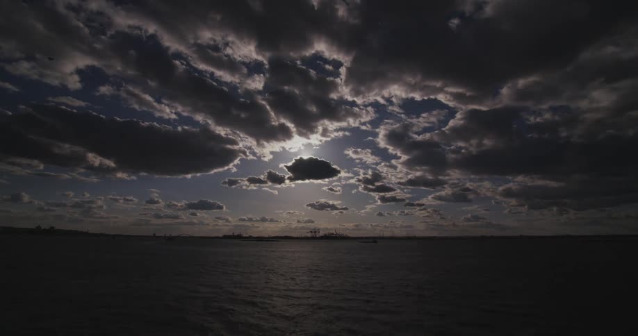 The sun shines and glistens on a large body of water