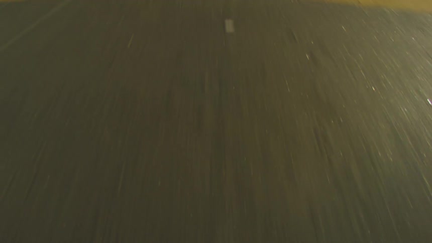 Driving fast on a concrete road with warm light shining