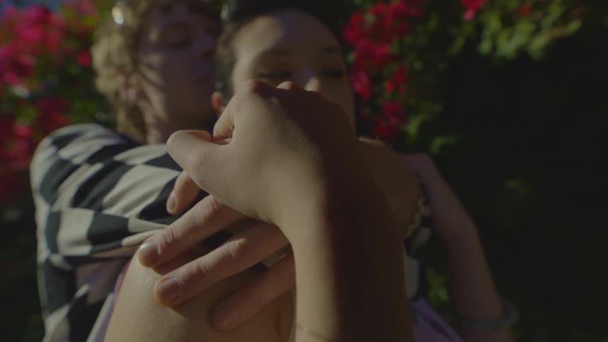 A man and woman hug outside