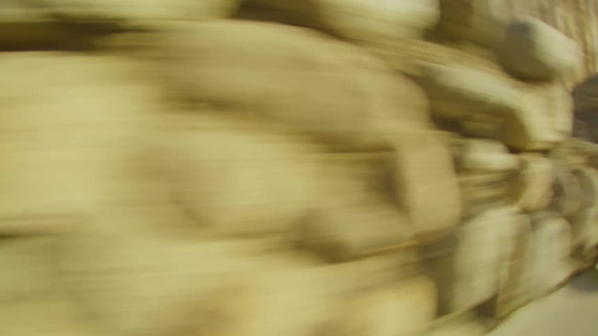 A view of a stone wall outdoors on a sunny day