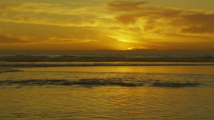 A beach with the sea illuminated by morning sunlight