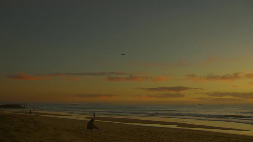 The plane flies over the coast of the beach