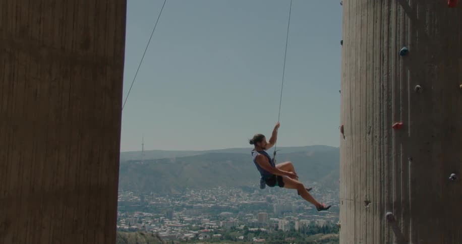 A clip of a man climbing down from a wall