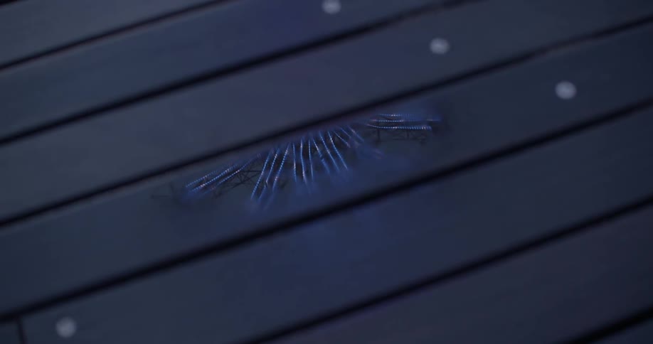 A reflection in a puddle on a wood porch