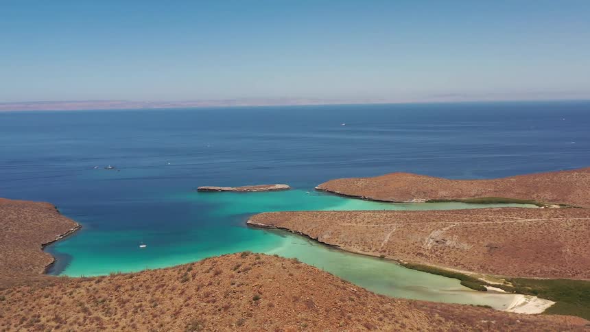 Aerial of a paradisiacal beach with mountains during the day