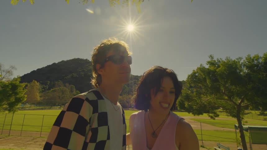 Portrait of a man and a woman smilingly humiliating themselves and then running