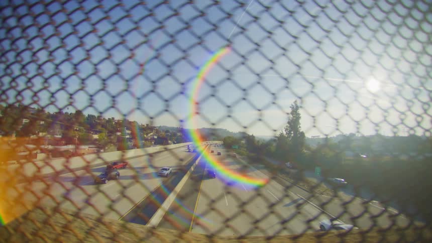 A view of some cars driving down a highway from a bridge over it