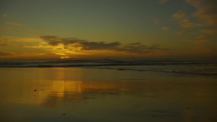 The sun is setting on the beach