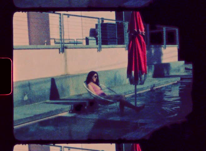 A woman is sitting by the pool