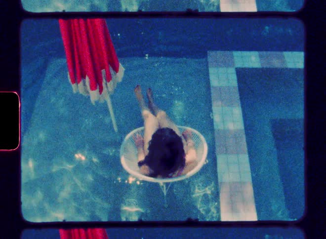 Woman sitting on a chair inside the pool and tapping her feet