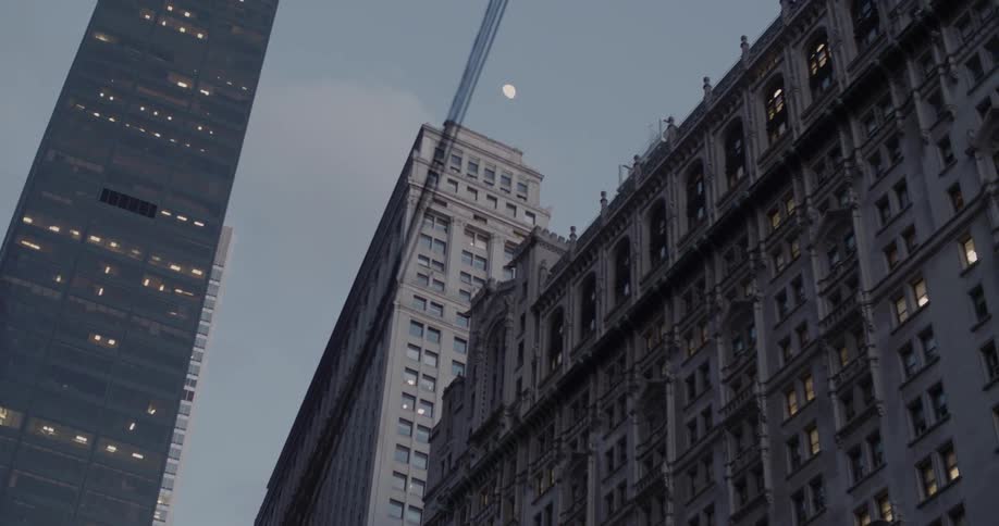 Power lines hang above a city with large city buildings behind it