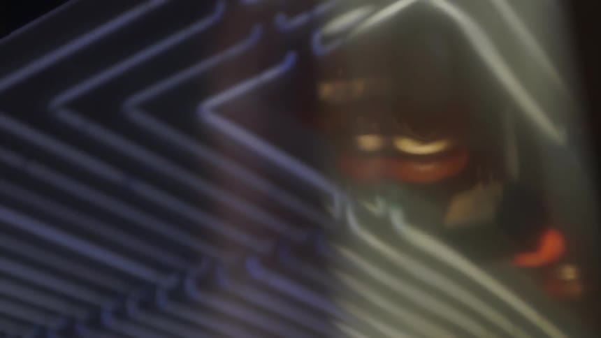 Close up of a reflective surface with parallel pipes in the background