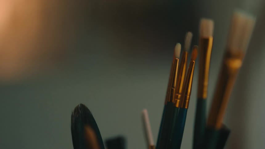 A group of different size paint brushes are together