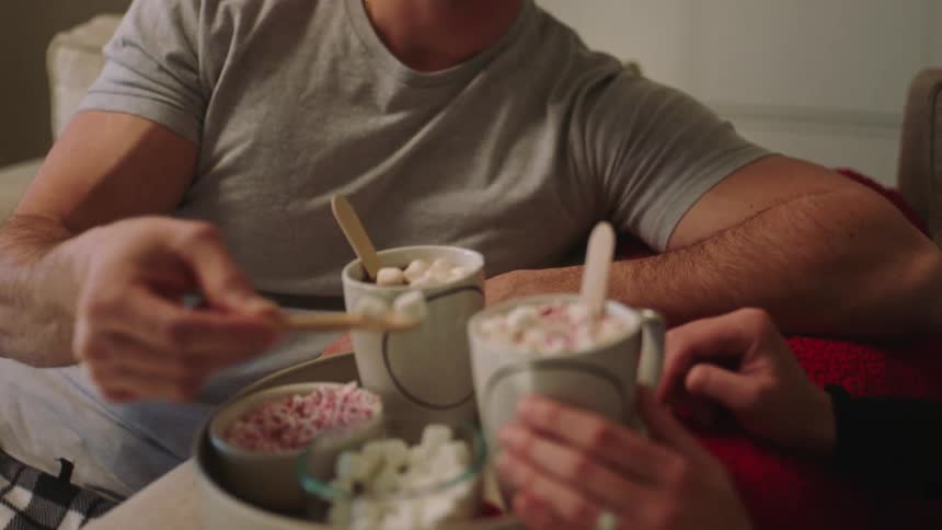 A man putting some candies in his drinks