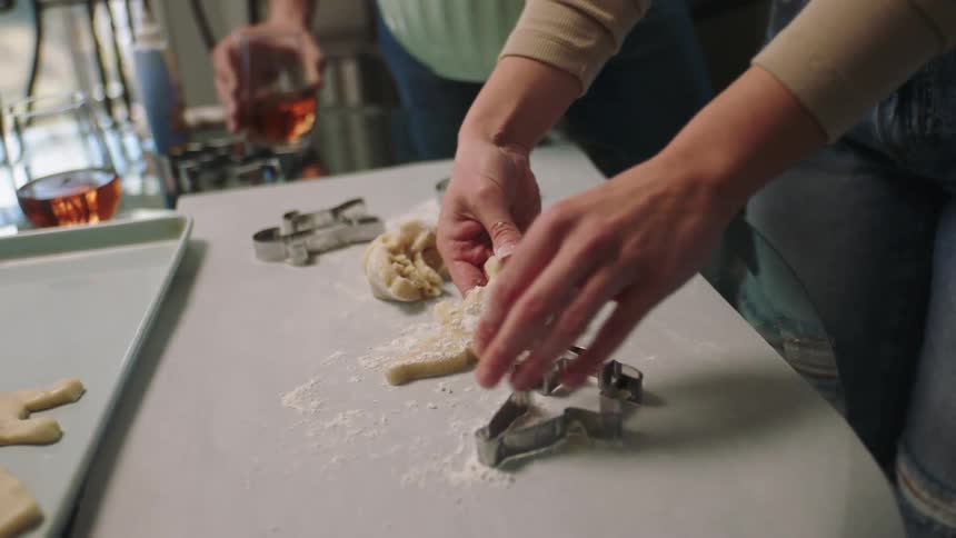 A clip of a person baking and another dinking a wine