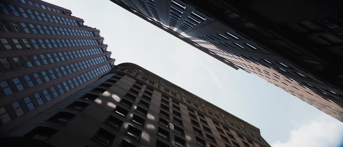 Two city buildings across a narrow street from each other
