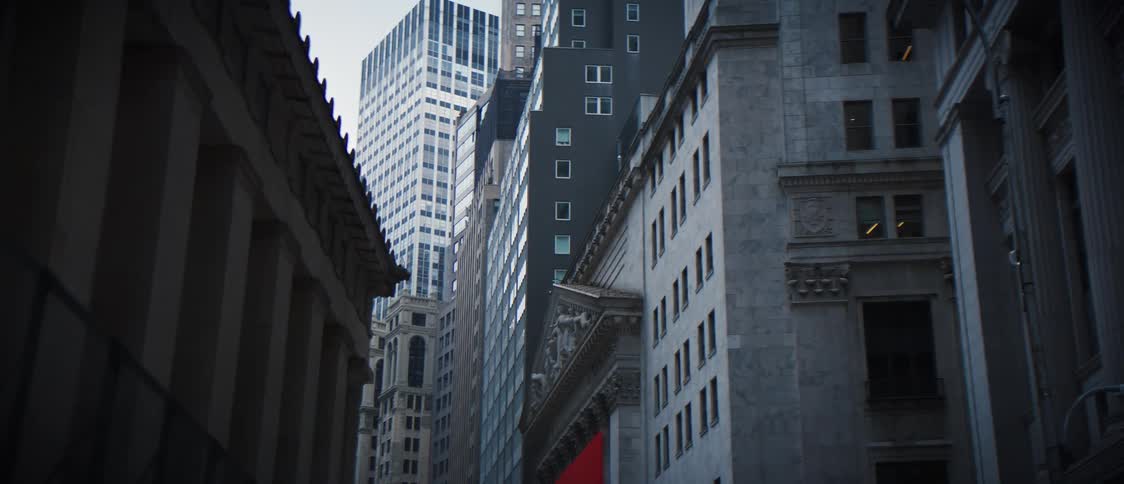 A city street leading to a tower block