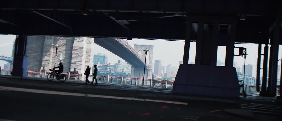 People are traveling under the dark overpass