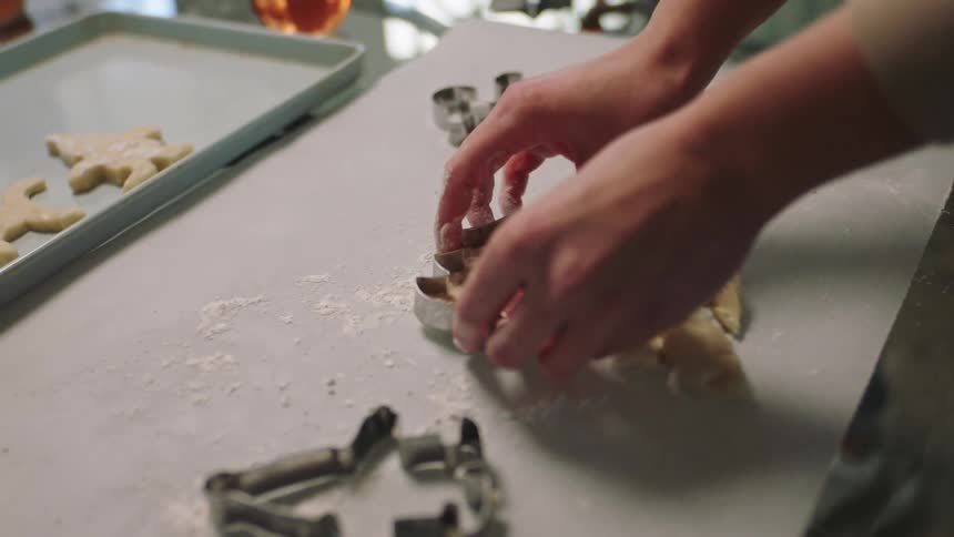 A person is making christmas cookies